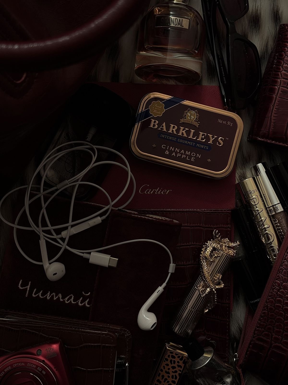 Earphones on a burgundy flatlay